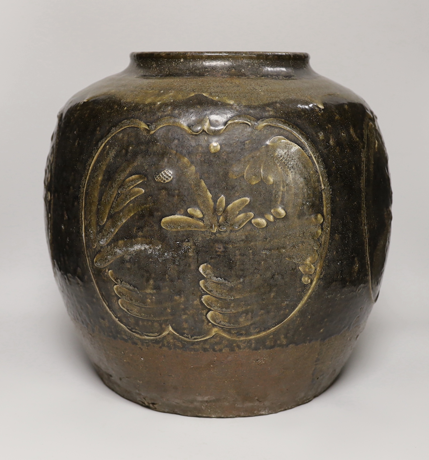 A large Chinese stoneware ovoid jar, decorated in relief with birds and flowers, possibly 19th century, 36cm high